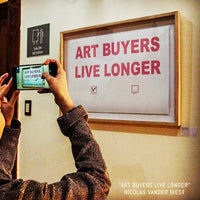 ARTWORK by Nicolas Vander Biest "ART BUYERS LIVE LONGER" pink uppercase text on white paper.