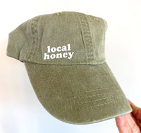 local honey twill pigment dyed dad hat. khaki.heat pressed lower case lettering.