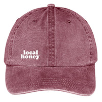 local honey twill pigment dyed dad hat. maroon. heat pressed white lettering.
